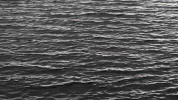 Slow motion footage of the calm water surface with dark waters. Nature video