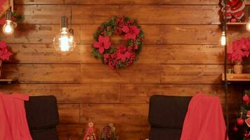 Christmas garlands on wooden wall in decorated room video