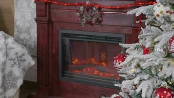 Beautiful decorated Christmas tree and a fireplace next to it. Dolly rack focus shot video