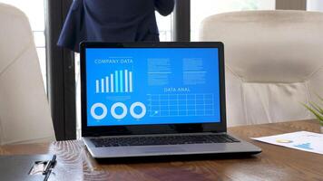 Laptop displaying company data and analysis in animated charts. Dolly slider 4K footage video