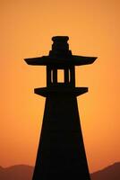 traditional Japanese lighthouse at sunset photo