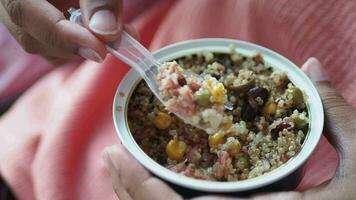 women eating canned bulgur rice mixed tin tuna video