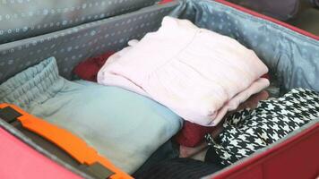 women bring all cloths out from luggage video