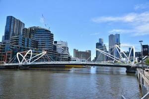 Melbourne, Victoria, Australia - 23 Dec 2023 - The Seafarers Bridge is a footbridge over the Yarra River between Docklands and South Wharf in Melbourne with skyscraper view at the background. photo