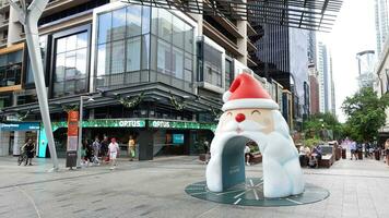 Brisbane, Queensland, Australia, - 6 January 2023 - Santa claus cartoon artwork statue at the centre of Queen Street Mall. photo