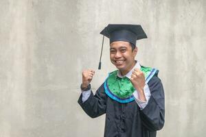 Young Indonesian guys celebration and cheers when graduation moment. photo