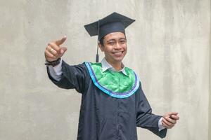 Young Indonesian guys celebration and cheers when graduation moment. photo