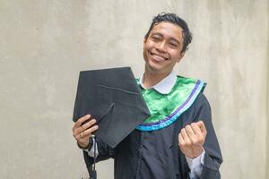 Young Indonesian guys celebration and cheers when graduation moment. photo