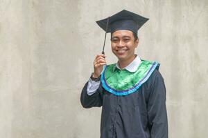 Young Indonesian guys celebration and cheers when graduation moment. photo