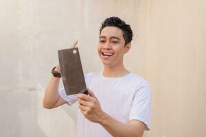 Young curly man hold the knife and think gesture wear white t-shirts. The photo is suitable to use for man expression advertising and fashion life style.2