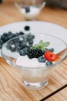 Dessert with wild berries. blackberries, blueberries, raspberries. Cream with berries at a cooking class. Cooking at home. photo