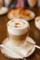 Delicious coffee Lattes in a glass cup on a table photo