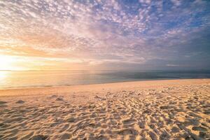 Closeup sea sand beach. Panoramic beach landscape. Inspire tropical beach seascape horizon. Orange and golden sunset sky calmness tranquil relaxing sunlight summer mood. Vacation travel holiday banner photo