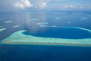 Tropical islands and atolls in Maldives from aerial view. Maldives tourism. photo