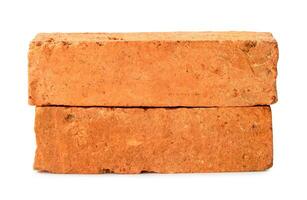 Front view of old red or orange cracked bricks in stack isolated on white background with clipping path photo