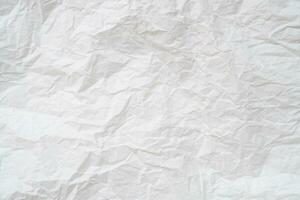 Wrinkled or crumpled white stencil or tissue paper used for crumpled paper background texture photo