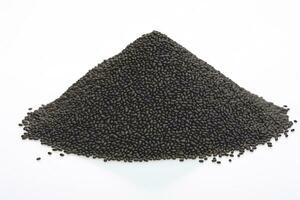AI generated Black sesame seeds in a heap, isolated on a white background, ideal for culinary and food concepts. photo