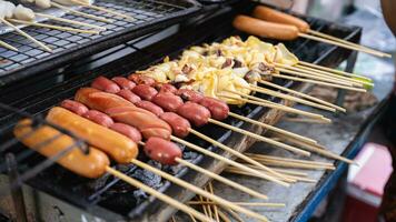 Squid and Sausages Burning at street food, Bangkok-Thailand. photo