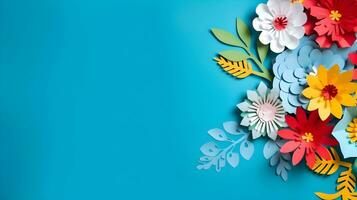 AI generated Top view of colorful paper cut flowers with green leaves on blue background with copy space. photo
