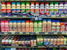 Blur image of shelf with consumer product shop in supermarket photo