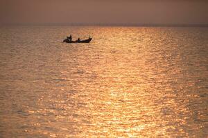 boats is floating againts colorful sky at sunset time photo