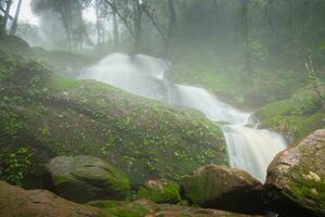 waterfall in forest in rain season photo