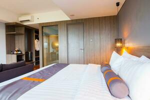 Interior of superior bedroom with white bed and pillow photo