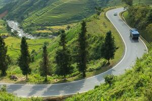 Curve of road across mountain on hill photo