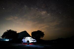 Night sky of milky way with car photo