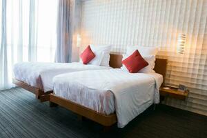 Modern bedroom interior with red pillow on white bed photo