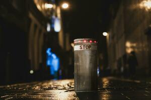 Night shot of a retractable bollard in in a city street photo