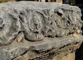 The element of the gate of Hadrian on the ground near the gate. Ruins of ancient construction. photo