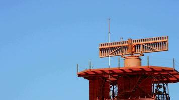 Malaga, Spain, 2017 - Passenger airplane taking off over telecommunications tower with radar gyrating video