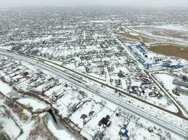 Winter view from the bird's eye view of the village. The streets are covered with snow photo