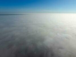 In the skies above the fog. Sunrise over the fog. Clouds near the ground photo