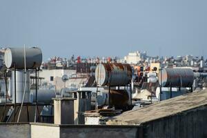 Steel barrels of boilers with water on the roof of a building to heat water photo