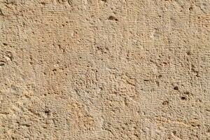 Texture of processed ancient marble block. Traces of ancient tools photo