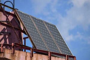 Solar panels at the top of the lighthouse. Transformation of solar energy. photo