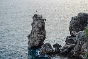 Limestone cliffs by sea. Waves beat on the rocks. photo