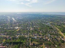 Top view of the village. One can see the roofs of the houses and gardens. Road and water in the village. Village bird's-eye view photo