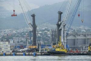 The international sea port of Novorossiysk. Port cranes and industrial objects. Marine Station. photo