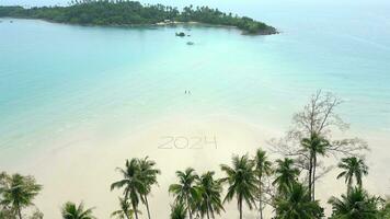 The year 2024 written on a tropical beach. Concept of a beach getaway in 2024. video