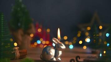 a candle burns in the form of a rabbit, a symbol of 2023 photo