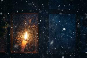 Christmas, new year, winter composition. Candle behind a frozen window photo