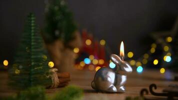 a candle burns in the form of a rabbit, a symbol of 2023 photo