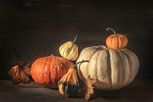 Autumn arrangement with pumpkins and maple leaves photo