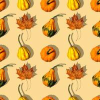 seamless pattern different pumpkins on a orange background photo