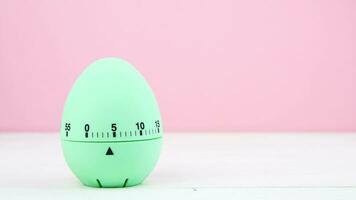 4K blue kitchen egg timer on a pink background. cooking time, soon Easter photo