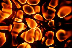 Beautiful liquid fire texture on black background photo