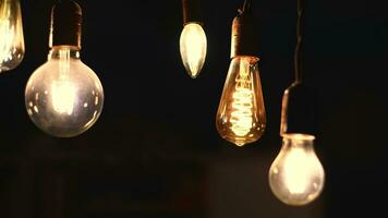 Retro light bulbs hanging on a dark background. Electricity, Vintage photo